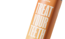 A tall cylindrical silver Plastic Bottle with a bright orange label that has Hismile Peach Iced Tea written in bright white writing on it, on a white background.
