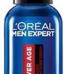 A short rounded cylindrical clear glass bottle full of some clear liquid with a black rubber pipette lid and a dark blue label that has L’Oreal Paris Men Expert Power Age hyaluronic Acid Serum written in bright white writing on it, on a white background.