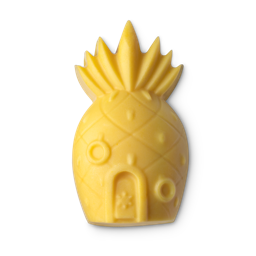 A medium neon orange pineapple shaped massage bar that has some windows and a door engraved on it, on a white background.