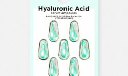 seven small teardrop shaped plastic ampoules full of some clear liquid encased in some clear plastic on a medium rectangular piece of white cardboard that has Primark PS… Skin + Hyaluronic Acid Serum Ampoules written in bold black writing on it, on a white background.