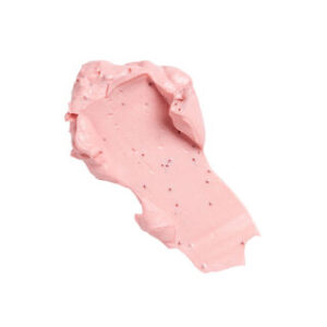 A medium circular puddle of some bright pink face mask that has some pieces of Sugar Sprinkles running through it, on a white background.