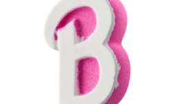 A large bright pink cursive letter B shaped Bath Bomb that has a large bright white cursive Letter B engraved on it, on a white background.