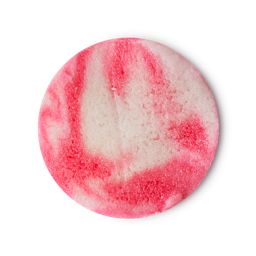 A medium circular puddle of some gradient bright pink and white Body Scrub that has some pieces of Castor Sugar running through it, on a white background.
