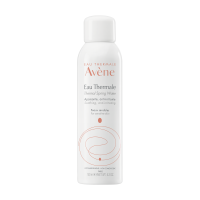 A Nice Calming Mist Always Calms My Hot Skin Down | Avène Thermal Spring Water Spray A tall cylindrical metallic white Metal canister with a black plastic lid that has Avène Thermal Spring Water spray written in bright orange writing on it, on a white background.