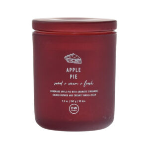 A tall cylindrical dark red glass jar with a dark red glass lid and a dark red label that has DW Home Candles Apple Pie written in bright white writing and a picture of an Apple Pie on it, on a white background.
