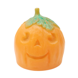 A large bright orange spherical Pumpkin shaped block of soap with a dark green stalk that has a smiley face engraved on it, on a white background.