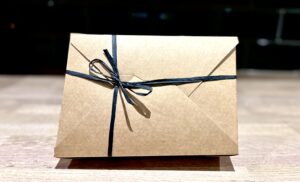 A large rectangular brown cardboard box tied with some light brown twine with a white label that has Fancy Jacks 6 Jack Treat Box written in bold black writing on it, on a white background.