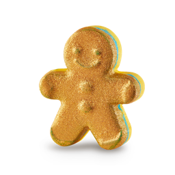 A medium light brown gingerbread man shaped bath bomb that’s coated in some bright gold lustre, on a white background.