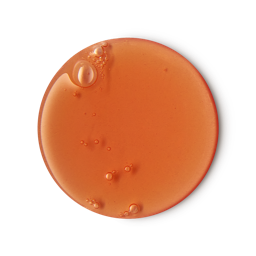 A medium circular puddle of some creamy apricot Orange shower gel, on a white background.