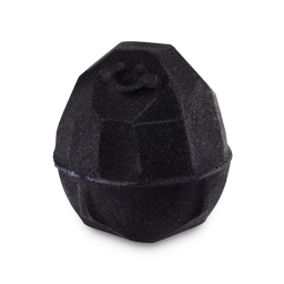 A small dark black lump of coal shaped bath bomb that’s covered in some bright gold lustre, on a white background.