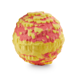 A medium spherical gradient bright red and yellow marigold flower shaped bath Bomb that’s coated in some gold lustre, on a white background.