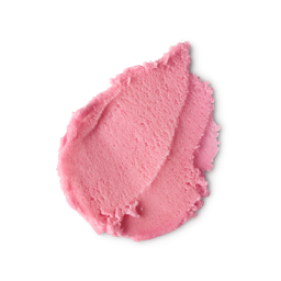 A medium circular puddle of some pastel pink body scrub that has some pieces of ground white rice running through it, on a white background.
