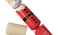 A medium rectangular bright red and white cracker shaped block of Soap that has a Santa’s Face with a White Beard and a black belt with a bright gold buckle Engraved on it, on a white background.
