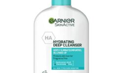A tall rounded rectangular bright white plastic bottle with a bright green plastic pump lid that has Garnier SkinActive written in bright green writing and Hydrating Deep Cleanser written in bold black writing on it, on a white background.
