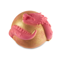 A medium golden orange spherical shaped bath bomb that has a bright magenta pink Chinese Dragon wrapped around it, on a white background.