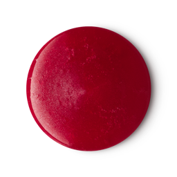 A medium circular puddle of some shimmering dark red shower gel, on a white background.