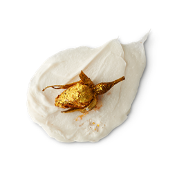 A medium circular puddle of some creamy white body wash that has a bright red Rosebud coated in some gold Lustre running through it, on a white background.