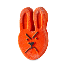 Fairytales Are Real | Lush Unicorn Horn Bubble Bar and Prince Charming Shower Cream A medium dark orange rabbit’s head shaped bubble bar that has a grumpy face engraved on it, on a white background.