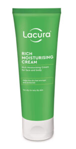 A tall conical dark green plastic tube with a bright white plastic lid that has Aldi Lacura Rich Moisturising Cream written in bright white writing on it, on a white background.
