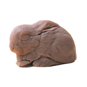 A medium dark brown crouching bunny rabbit shaped block of soap, on a white background.