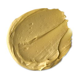 A medium circular puddle of some dark golden yellow face & Body Mask, on a white background.