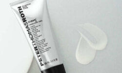 - [ ] A tall conical bright silver plastic Tube with a black plastic lid that has Peter Thomas Roth written in bright silver writing and FIRMx® Peeling Gel written in bold black writing on it next to a medium circular puddle of some translucent white liquid, on a white background.