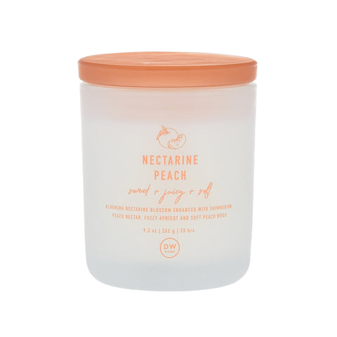 That Smell Is Just Peachy | DW Home Candles Nectarine Peach A tall cylindrical clear Glass Jar full of some creamy white wax with a bright peach glass lid and a bright white label that has DW Home Candles Nectarine Peach written in bright peach writing on it, on a white background.