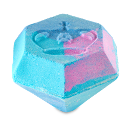 When You Hold Me, I’m Alive, We're Like Diamonds In The Sky | Lush X Bridgerton Range | Gifted A large gradient bright blue and pink diamond shaped bath bomb that has a crown engraved on the top of it and is covered in some silver lustre, on a white background.