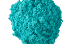 A medium circular puddle of some bright teal showder, on a white background.