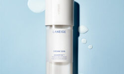 A tall cylindrical bright white plastic bottle with a bright white plastic lid that has Laneige Cream Skin Toner & Moisturiser written in dark bluie writing on it, on a white background.