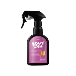 A tall black plastic kitchen spray bottle with a bright purple label that has Lush Grape Soda Body Spray written in bright white writing on it, on a white background.