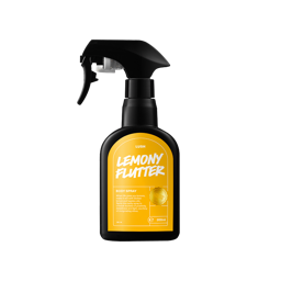 A tall black plastic kitchen spray bottle with a bright yellow label that has Lush Lemony Flutter Body Spray written in bright white writing on it, on a white background.