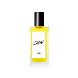 A tall rectangular clear glass bottle full of some bright Canary Yellow liquid with a bright white label that has Lush Sun Eau De Cologne written in bold black writing on it, on a white background.