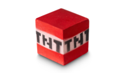 A medium bright red cube shaped bath bomb that has a white stripe in the middle of it and TNT engraved on it, on a white background.