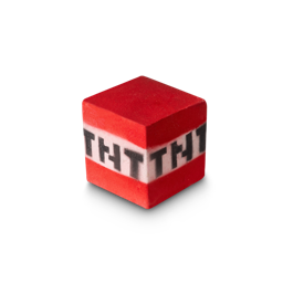 Little Tricks I Try, Stack The Blocks Up High | Lush x Minecraft Range A medium bright red cube shaped bath bomb that has a white stripe in the middle of it and TNT engraved on it, on a white background.