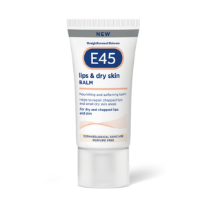 A short flat conical bright white plastic tube with a clear plastic lid that has E45 written in bright white writing, Lips & Dry Skin Balm written in dark blue writing, a picture of a dark blue oval, and a picture of a dark grey stripe on it, on a white background.