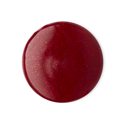 A medium circular puddle of some sparkling dark red shower gel, on a white background.