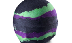 A medium gradient dark black, Green and Purple rounded hexagonal shaped bath bomb, on a white background.