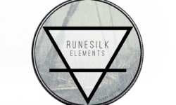 A short cylindrical silver metal tin with a silver metal lid and a gradient dark grey label that has Runesilk Elements Earth Beard Butter written in bold black writing and a picture of a bright white triangle on it, on a white background.