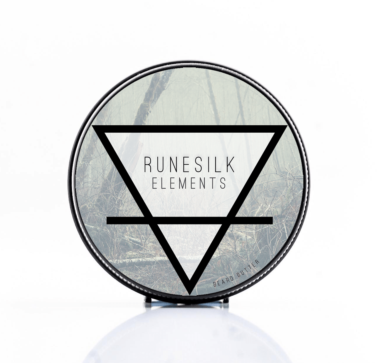 Using All Of The Elements Of The Earth To Get A Soft Beard | Runesilk Elements Earth Beard Butter | Discount A short cylindrical silver metal tin with a silver metal lid and a gradient dark grey label that has Runesilk Elements Earth Beard Butter written in bold black writing and a picture of a bright white triangle on it, on a white background.