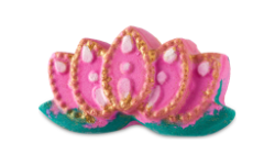 A medium bright pink lotus blossom shaped bath bomb that has five sparkling fanned petals coming out of the side of it and some dark green leaves engraved on it, on a white background.