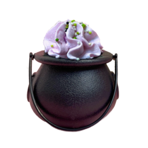 A medium circular black plastic Witch's Caldron with a black plastic handle full of some swirled light purple solid cocoa butter that’s covered in some bright black, green and white Sprinkles, on a white background.