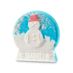 A medium bright white flattened snow globe shaped bath bomb that has a sparkly bright blue dome, a bright white snowman with a bright red top hat, and Lush engraved on it, on a white background.