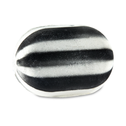 A large bright white and black striped compressed oval sweet shaped bath bomb, on a white background.