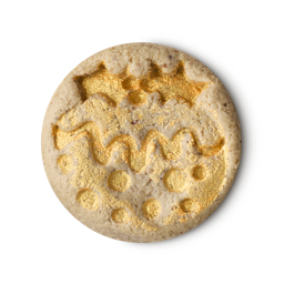 A medium circular puddle of some light caramel cleanser that has some pieces of Castor Sugar running through it and a picture of a glittery Christmas Pudding engraved on top of it, on a white background.