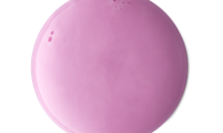 A medium circular puddle of some glossy pastel pink shower gel, on a white background.