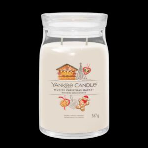 A tall cylindrical glass jar full of some creamy white wax with a label that has Yankee Candle written in bright white writing, Munich Christmas Market written in bright white writing, and a picture of a gingerbread house, a large dark green Christmas tree, a heart Christmas Tree Ornament, and a medium circular golden brown cookie on it, on a white background.