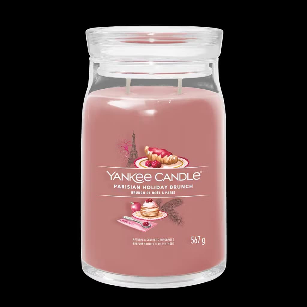 Let's Do Brunch! | Yankee Candle Sunday Brunch Collection A tall cylindrical glass jar full of some pale pink wax with a label that has Yankee Candle written in bright white writing, Parisian Holiday Brunch written in bright white writing, and a picture of a pile of some golden pancakes covered in some raspberries, a golden brown croissant, and the Eiffel Tower on it, on a white background.
