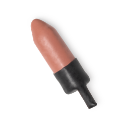 A short cylindrical nude pink lipstick that’s coated in some light pink wax, on a white background.