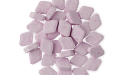 A small pile of some pastel pink rounded diamond shaped mouthwash tabs, on a white background.